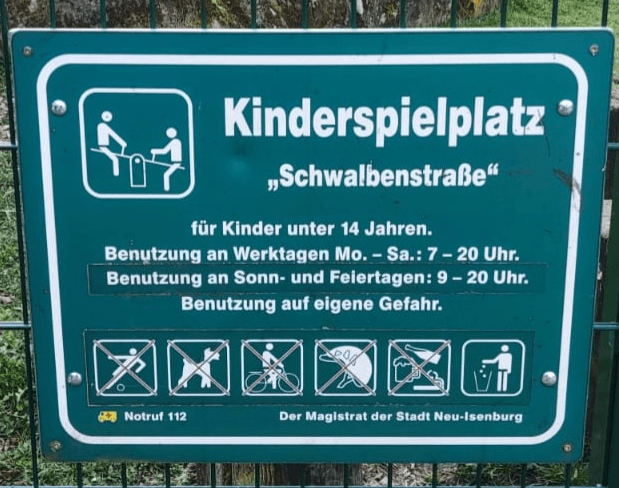 Almanya çocuk parkı kuralları ve yasaklarını gösteren yeşil renkli resmi tabela örneği
